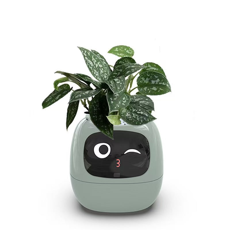 EMOKO smart pet planter robot with green leafy plant and digital face display in light green casing