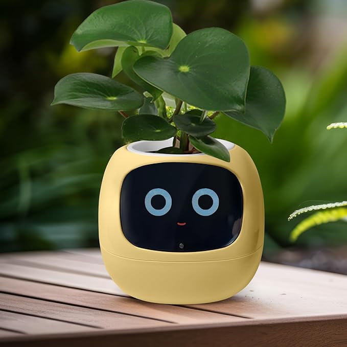 EMOKO smart pet planter robot in yellow with digital face and green plant on wooden table